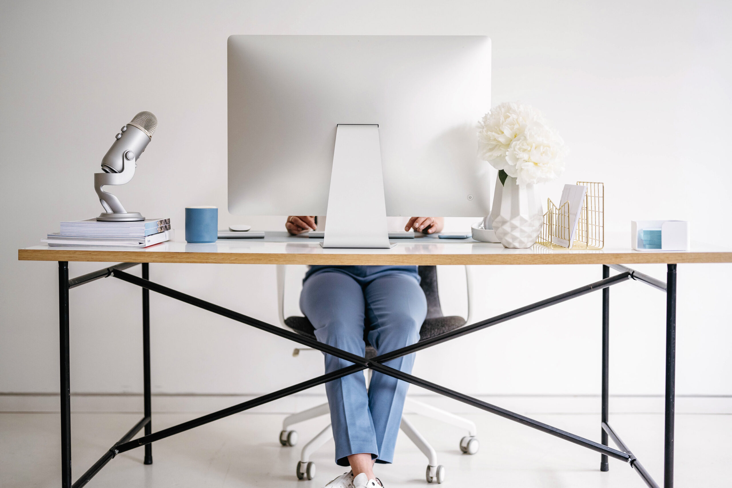 a woman sits at a desk