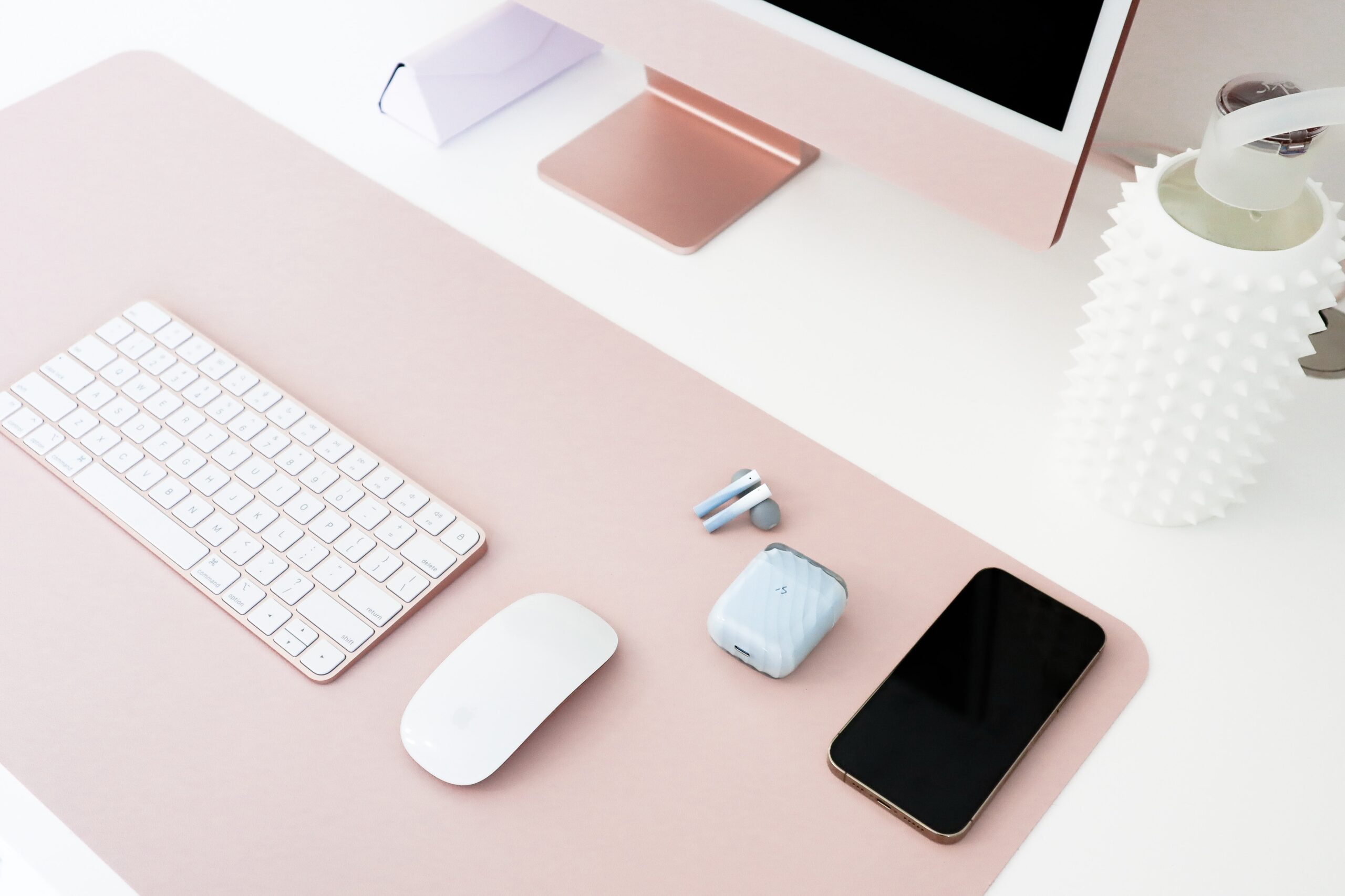 an image of a desk with a monitor, keyboard and a cell phone