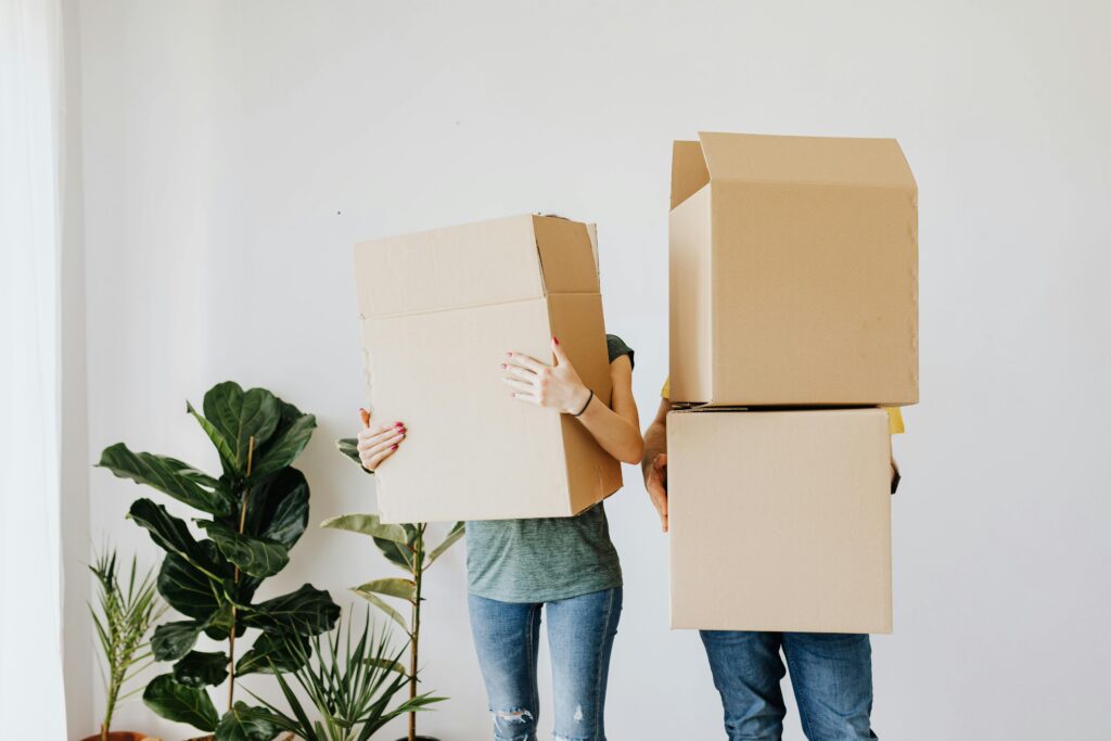 image of two people moving boxes
