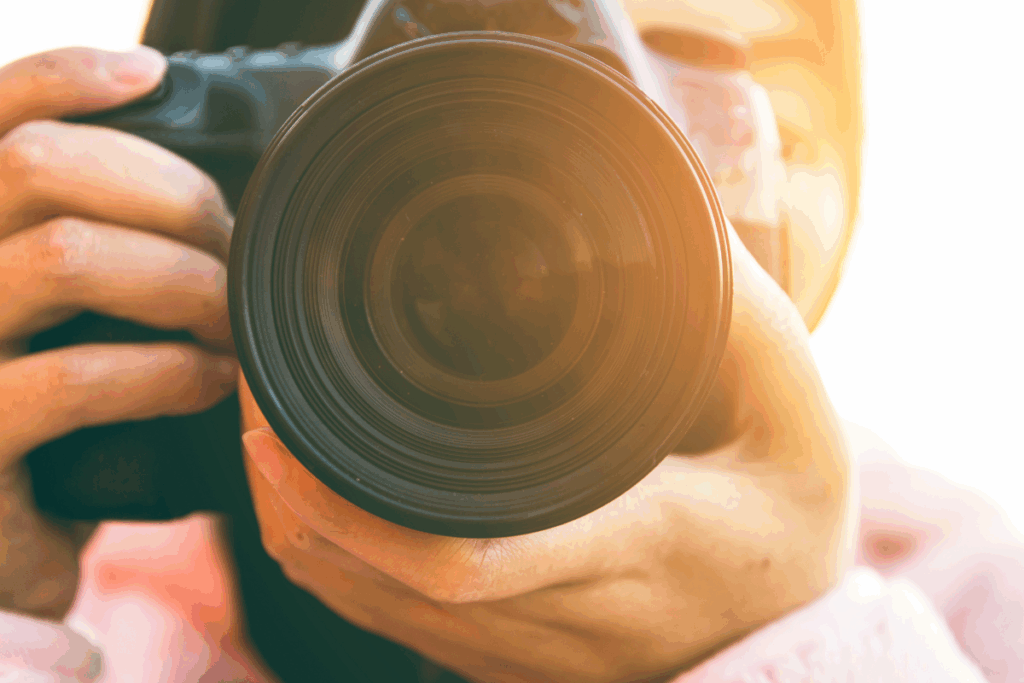 Part-Time Jobs for Photographers: How to Bridge the Income Gap Without Losing Your Business 1 Part-Time Jobs for Photographers: How to Bridge the Income Gap Without Losing Your Business a close up of a camera being held by a photographer