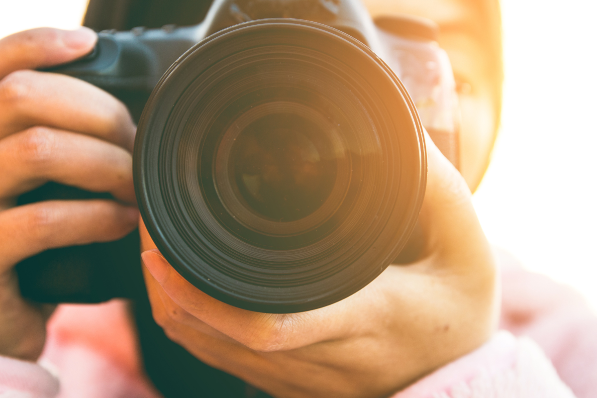 a close up of a camera being held by a photographer
