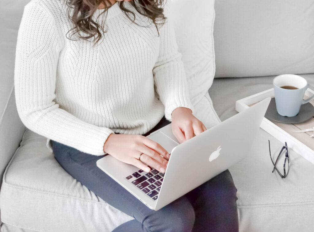 a photographer works on her laptop doing image seo