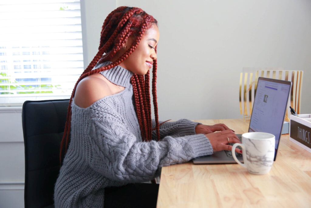 a photographer sits at her desk learning about email marketing for photographers
